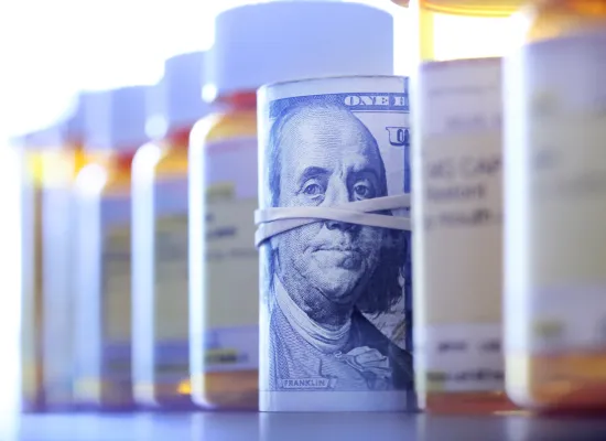 A roll of $100 bills in between prescriptions