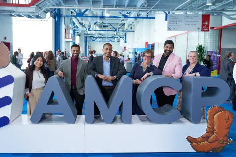 Group in front of amcp sign